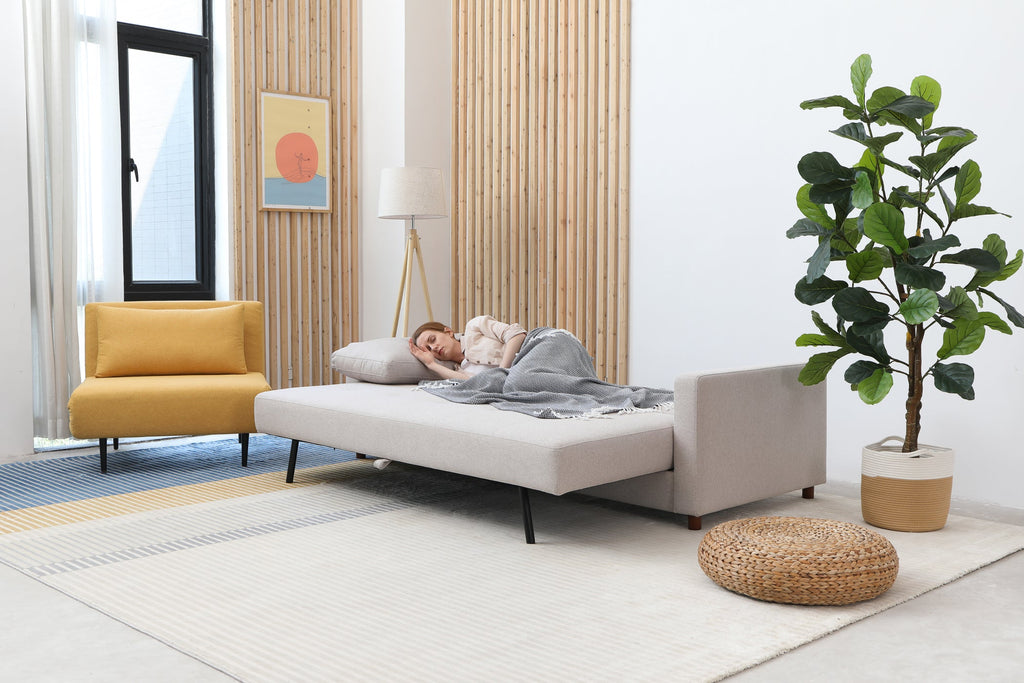 Three-seat sofa bed with plush cushions
